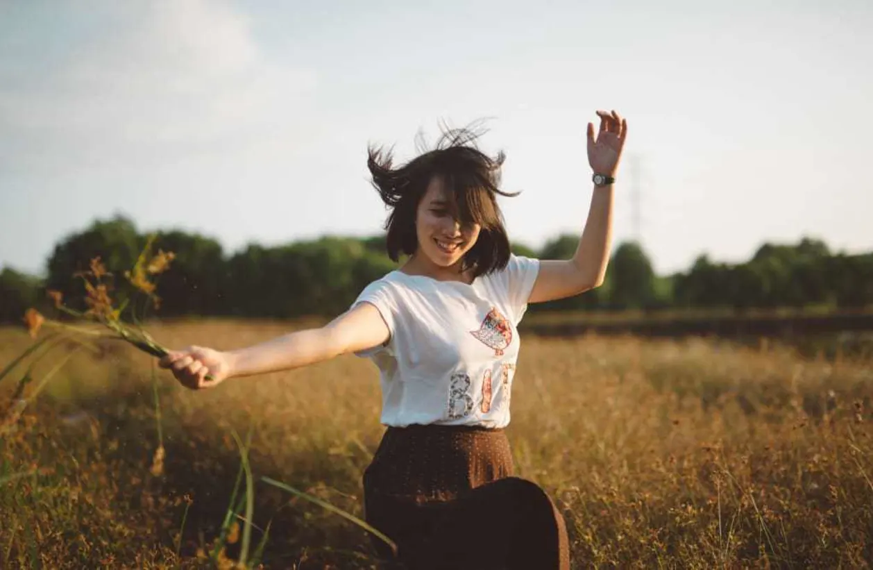 Female dancing in field - Daily Rituals to Boost Your Immunity